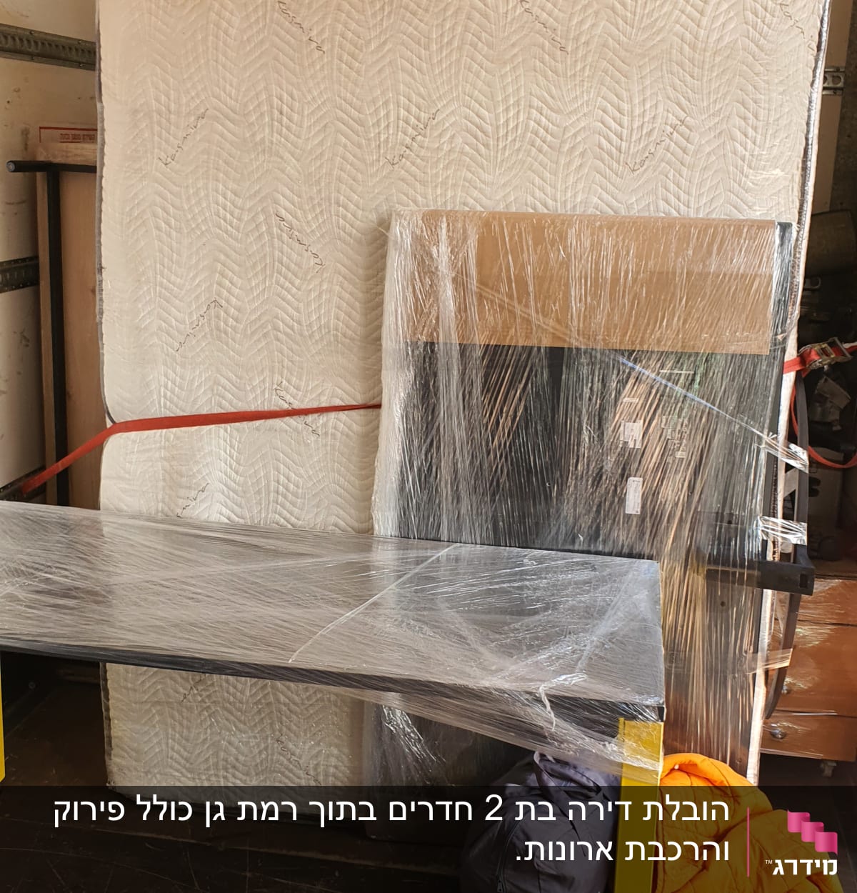 מזרן ושולחן עטופים בניילון בתוך משאית הובלה
